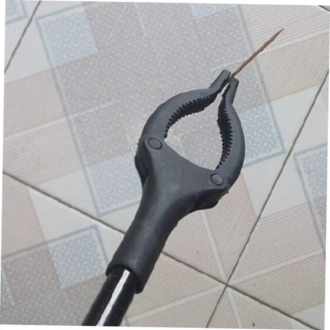 Extendable Garbage Grabber Stick With Smooth Clamp holding a small twig on tiled floor