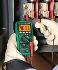 Person using Digital Multimeter With Auto And Manual Ranging And Non Contact Voltage Detection 6000 Count LCD in electrical panel