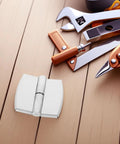 Self Closing Stainless Steel Door Hinge With Spring Auto Close Function For Public Restrooms next to tools on wooden surface