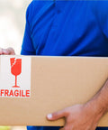 Red Fragile Warning Stickers With Strong Adhesive For Handle With Care Labels On Shipping And Packing Boxes held by person