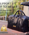 Gold Finish 22K Purse Hook For Table holding a black handbag off the floor, heart shaped, supports up to 30 lbs, perfect for travel or office.