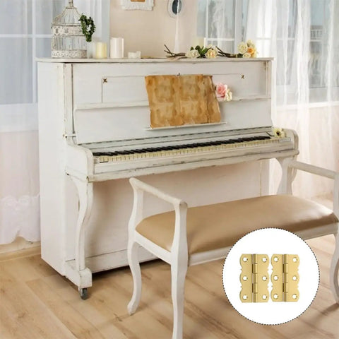 Copper Butt Hinges 4 Pack For Cabinet Doors And Tool Boxes, shown near a vintage white piano and bench.