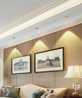 Top Tier Brass LED Recessed Downlight 4.5 Inch Adjustable Directional Ceiling Spotlight illuminating artwork in living room.