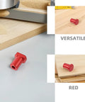 Red six pack aluminum bench dogs for woodworking with low profile, scratch resistant table stops on a workbench.