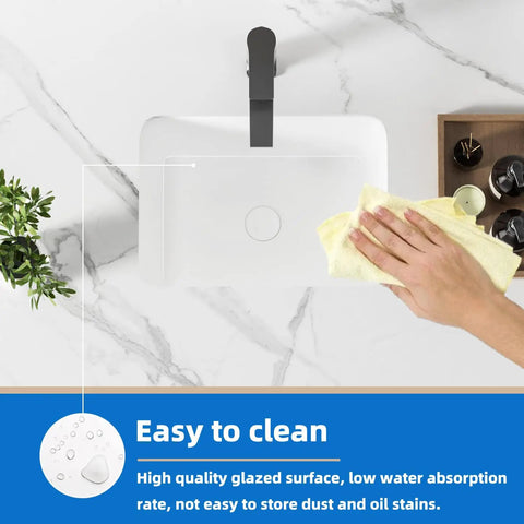 Person cleaning compact white porcelain undermount bathroom sink for small bathrooms and RVs rectangular ceramic basin