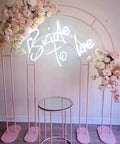 Bride To Be Neon Sign For Wall Decor LED Neon Light with white glow on a floral arch setup, 50x50 cm, indoor use, bachelorette party decor