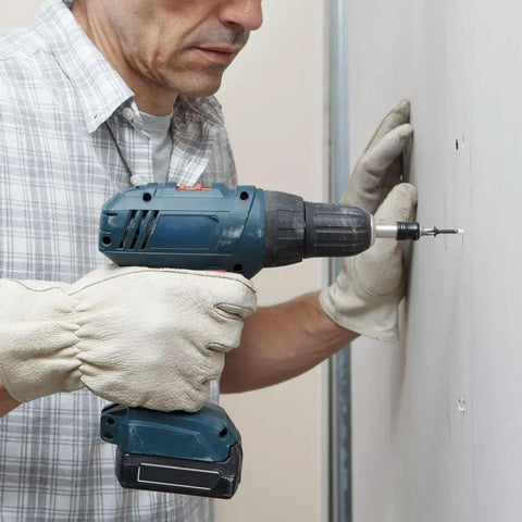 Man using a cordless drill to install Heavy Duty Coarse Thread Drywall Screws With Phosphate Coating on drywall.