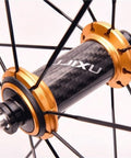 Close-up of a carbon hub and gold spoke assembly on Beefy Lightweight 700C Road Bike Wheelset With Double Wall Aluminum Rims 40mm.
