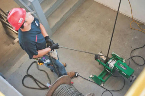Worker operating Heavy-Duty UT10-22 Puller for Cable and Wire Pulling, Pro-Grade Tool Built for Real-World Job Site Toughness