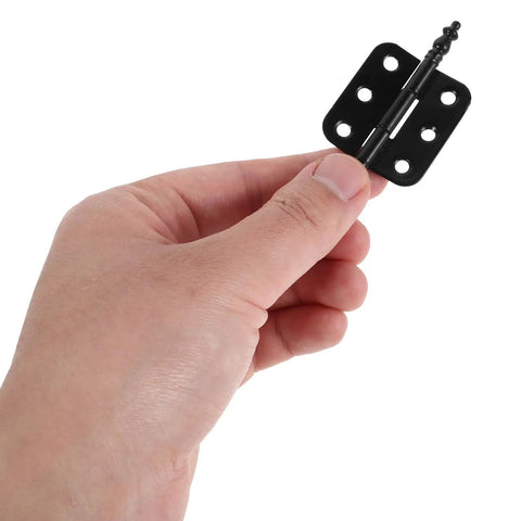 Close-up of a hand holding an antique-style hinge from a 10 Pack Antique Hinges for Wooden Boxes and Jewelry Cases set.