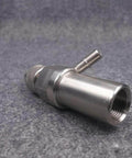 Side view of stainless steel waterjet mixing chamber adapter with side inlet nozzle and threaded bore.