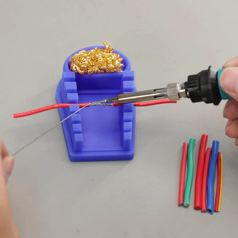 Blue Heat-Resistant Silicone Soldering Wire Holder with 6 Grooves, brass wool cleaner, and wires being soldered.