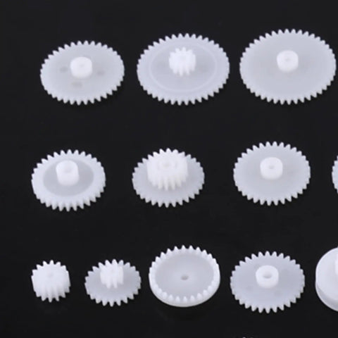 Grab This Awesome DIY Robot Gears And Pulley Belt Kit With 64 Kinds Of Wearable Plastic Parts Perfect For Tech Models, Car Robots, And Cool Motor Projects You Can Build Your Own Stuff With Today. White plastic gears set on black background