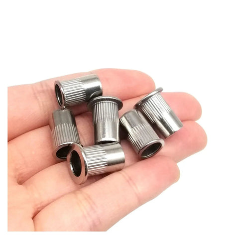 6 flat head threaded insert nuts made from 316 stainless steel with knurled design held in hand for project fixes.