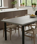 Modern kitchen with concrete countertop and dining table showcasing Pro Grade Water Based Concrete Countertop Sealer Kit Food Safe Formula.