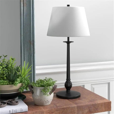 68 Inch Tall Floor Lamp With White Linen French Drum Shade In Blackened Bronze Finish on wooden table with plants