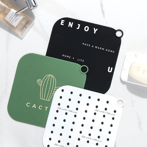Hair Stopper Shower Drain Strainers Silicone Adjustable, A set of colorful silicone mats in various designs on a countertop.