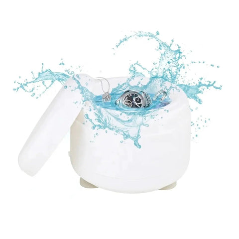 Premium Portable Ultrasonic Cleaner For Jewelry And Watches with rings and a watch in water, showing gentle cleaning.
