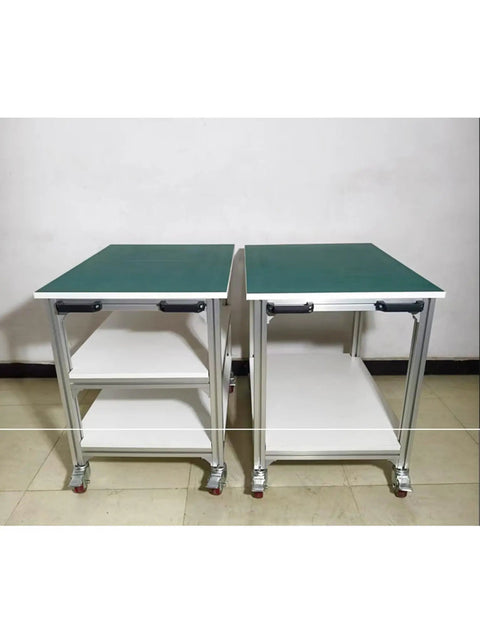 Side view of Heavy Duty Adjustable ESD Workbench With Wheels, showing two aluminum rolling tables with green surfaces.