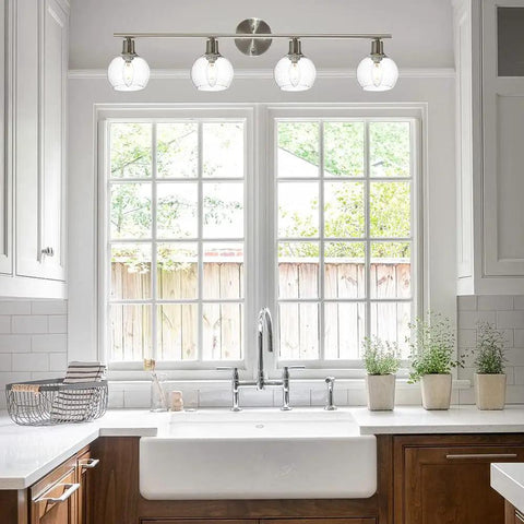Four Light Vanity Lighting Fixture With Globe Seeded Glass Shades In Brushed Nickel Finish Over Kitchen Sink