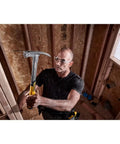 Man using Beast 14 Oz MIG Weld Hammer With Checkered Face ToughSeries in wood framing, showcasing fast swing and durability.