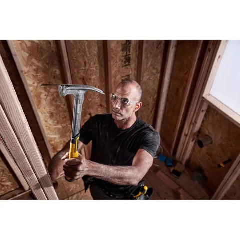 Man using Beast 14 Oz MIG Weld Hammer With Checkered Face ToughSeries in wood framing, showcasing fast swing and durability.