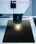 Front view of black laser engraving paper, 39×27 cm, with yellow edge under a laser engraving head