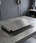 Heavy Duty Stainless Steel Ev Charger Rain Cover Weather Resistant Outdoor Charging Station Housing on a metal workbench.