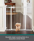 Extra Tall Walk Thru Pet Gate For Large Dogs With Adjustable Pass Through Door Pressure Mounted Safety Barrier No Sweat Setup Wide White Metal Dog Fence Rock Solid And Built Tough with a small dog passing through.