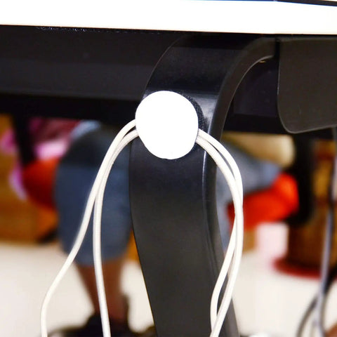 Heavy-Duty Removable Round Adhesive Hook And Loop Tapes for Wall Mounting attached to black table leg with cords secured