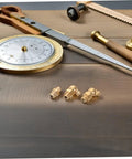 9 Piece Grease Fitting Assortment Kit With Copper Nipples For Cars And Trailers on wooden surface with brass fittings.