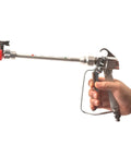 Heavy Duty Airless Paint Spray Gun With 3600 Psi Max Pressure And Reversible 517 Tip held in hand showcasing the ergonomic design.
