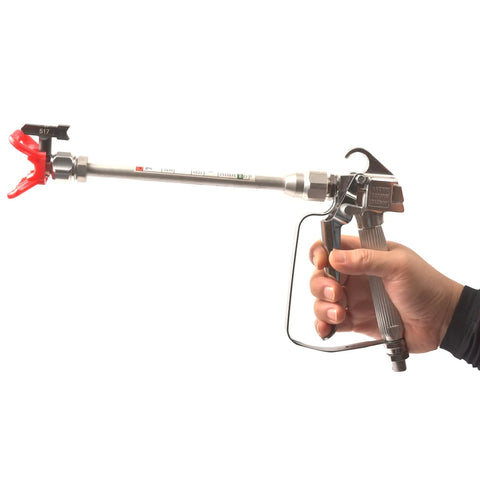 Heavy Duty Airless Paint Spray Gun With 3600 Psi Max Pressure And Reversible 517 Tip held in hand showcasing the ergonomic design.