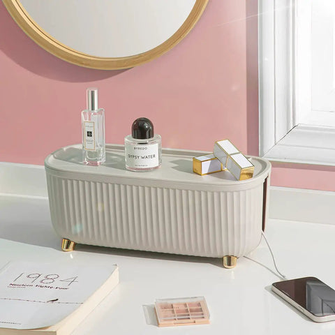Cable Management Box Cord Organizer 13.7 By 5.9 By 5.3 Inches For TV Computer And Laptop Power Strips Keeps Cords Neat Hidden And Clutter Free Sleek Light Beige For Home And Office on a bathroom counter with perfume bottles