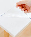 Clear 14 By 24 Inch Table Cover Protector With 1.5mm Thick Vinyl Desk Mat being installed on a white table.