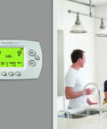 Smart 7-Day Wi-Fi Programmable Thermostat With Energy Star Rating on wall, couple in kitchen