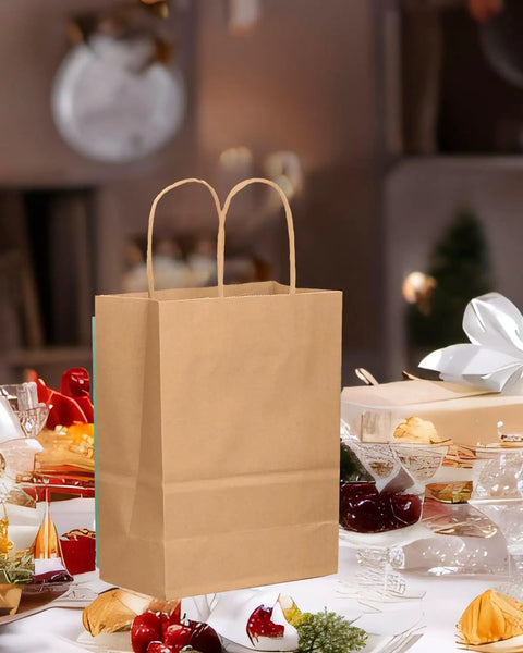 Brown kraft gift bag with handles on festive table 26 Pack Brown Kraft Gift Bags With Handles Bulk Small Size Gift Bags 8.3 x 3 x 6 Inches Eco Friendly Durable For Cookies Pastries And Small Gifts Party Favors And Bulk Buying