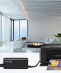 Universal 24V DC Power Supply Adapter 2.5A 60W With 8 Tips 100 240V AC To DC Converter connected to a printer in a modern living room