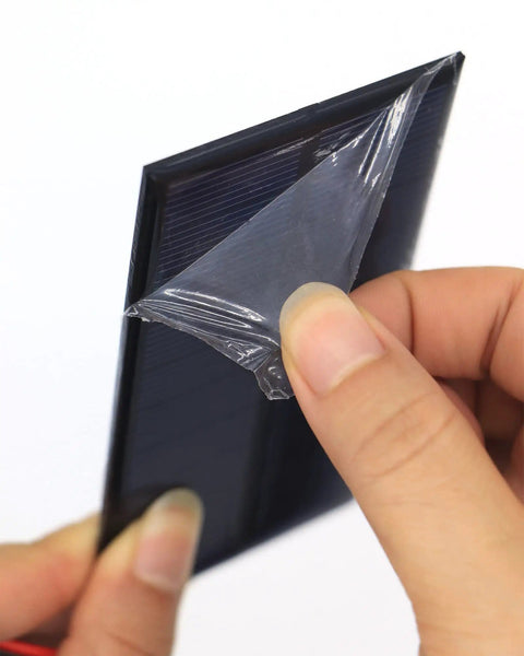 Hand removing protective film from Micro Solar Panels Kit With Wire Five Pack 5V 200mA Polycrystalline PV Cells 4.33 X 2.36 Inches