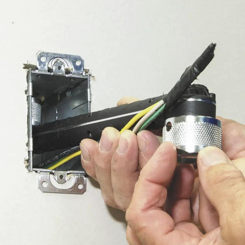 Conduit Locknut Wrench For One Half Inch And Three Quarter Inch Connectors With Direct Drive Heads in use with electrical wires
