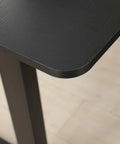 Close-up of the smooth, rounded edge of the brown top of the Mobility First Electric Standing Desk Height Adjustable Sit Stand Workstation.