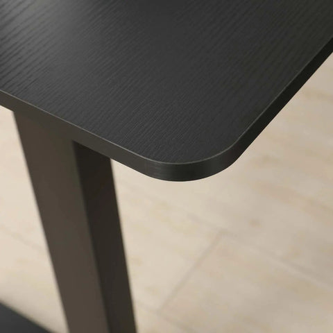 Close-up of the smooth, rounded edge of the brown top of the Mobility First Electric Standing Desk Height Adjustable Sit Stand Workstation.