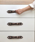 Vintage Zinc Alloy Door and Wardrobe Pull Handles Set in Coffee Brown on white cabinet, ergonomic safe and classy hardware.
