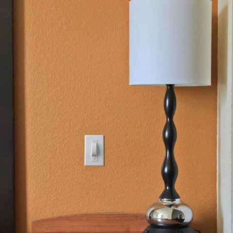 Room with a lamp and Childproof Light Switch Plate Covers 2 Pack White Safe Home Shield To Stop Little Ones And Curious Adults From Accidentally Flipping The Switch Easy Install Toggle Switch Shields next to the switch.