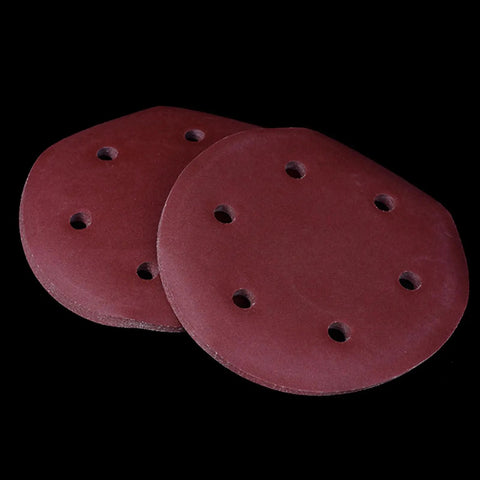 Rock Solid 50 Pack Of 9 Inch Aluminum Sanding Discs With 6 Holes And Hook Loop Backing stacked on black background.