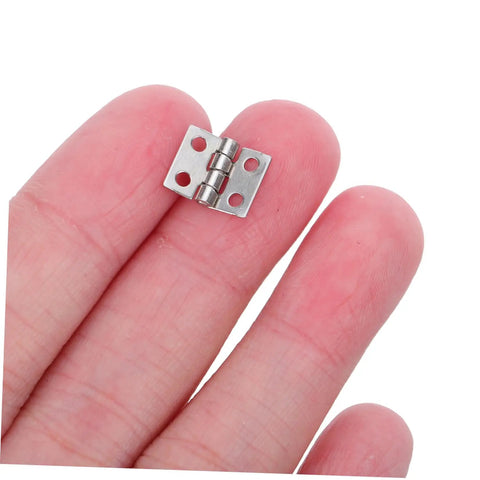 Lil Copper Miniature Hinges With Screws Pack Of 100 For Dollhouses And Tiny Boxes 10x8mm shown on fingertips for scale.