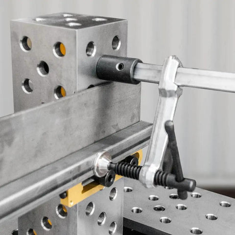 Inserta Clamps For 16mm Holes, Heavy Duty Workholding, 200mm Capacity, 100mm Throat, 181 kg Clamping Force, 20x10mm Rail, Vertical Or Horizontal Mount, Model UEN6200 clamping a metal rail on a fixture