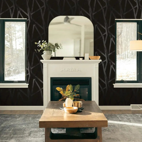 Living room with Geometric Metallic Black Intersections Peel and Stick Wallpaper by Genevieve Gorder, fireplace backdrop.