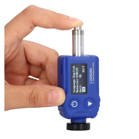 Heavy Duty Portable Digital Hardness Tester Featuring A Tungsten Carbide Impact Anvil And Built In Alloy Library For Quick Draw Testing and Rock Solid Knockout Accuracy Across All Metals, held in hand.