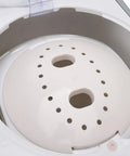 Inside view of No Sweat Portable Manual Hand Crank Clothes Washer with perforated inner drum for effective laundry.